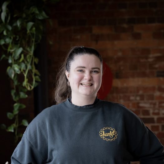 Team member Sophie, wearing a Hamlet jumper, smiling.